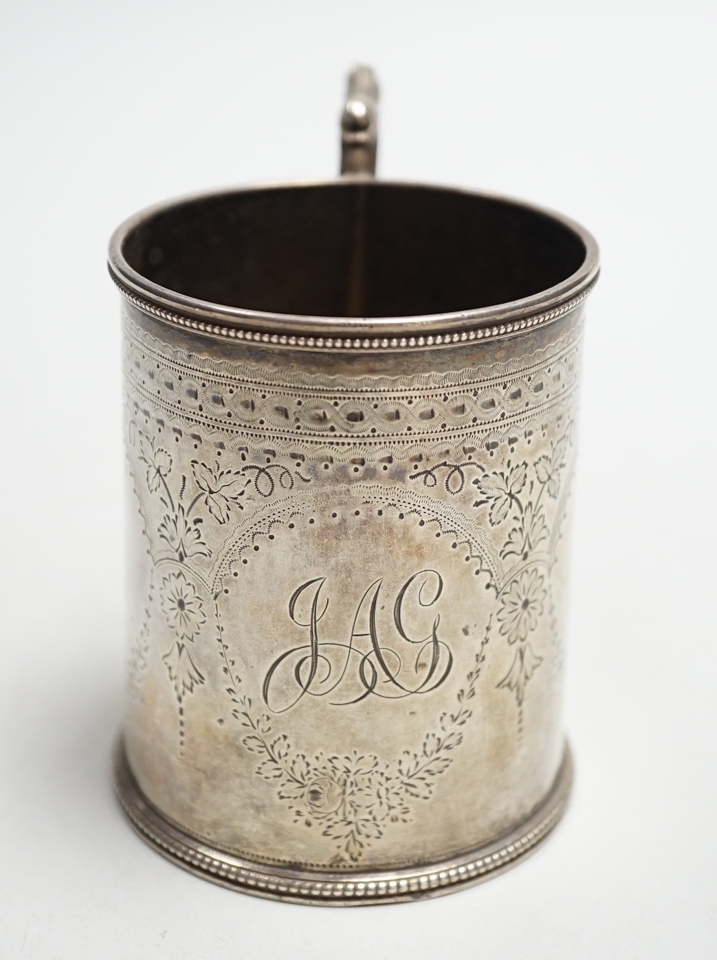 A Victorian engraved silver christening mug, Charles Stuart Harris, London, 1881, height 92mm, with engraved monogram.